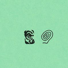 a tiny stamp of a spiral and an ear on a green cover